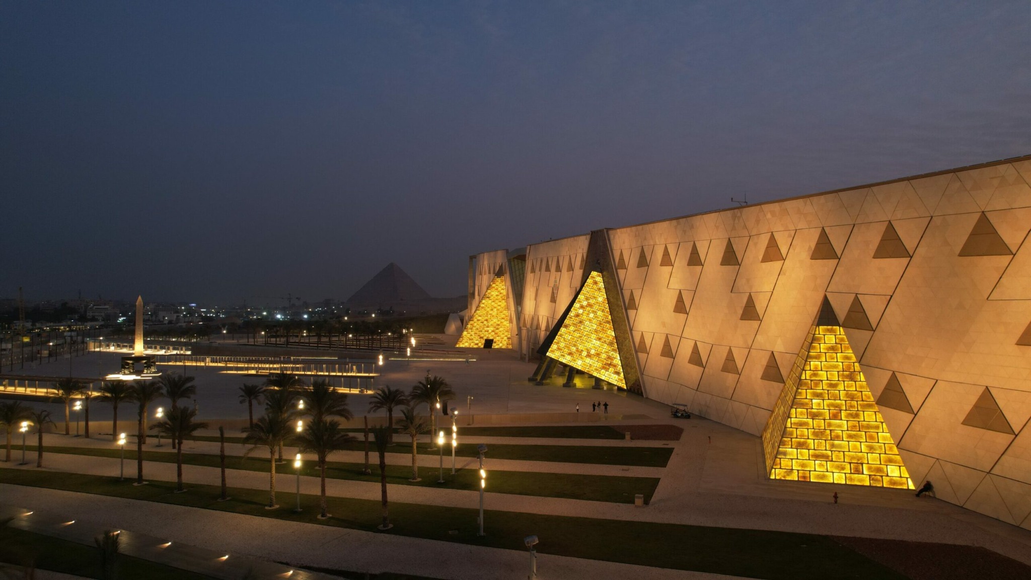 Grand Egyptian Museum illuminated at night in Giza